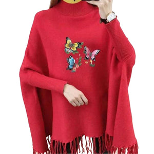 Red sweater with butterfly designs and fringes on a white background