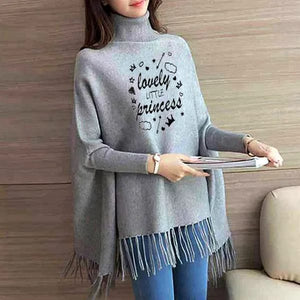 Woman wearing a gray poncho with 'lovely little princess' text, holding a book.