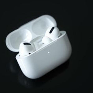 White wireless earbuds in a charging case on a black background